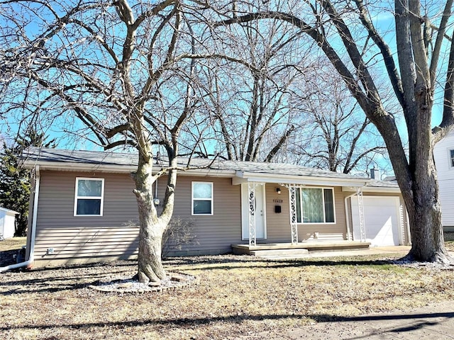 ranch-style home with a garage and covered porch