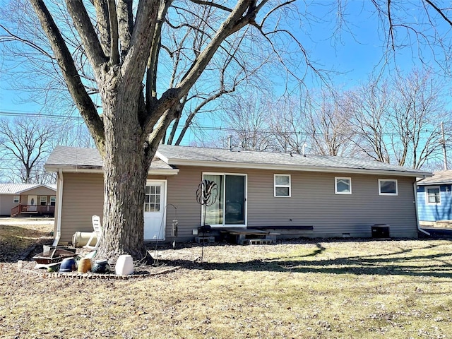 rear view of property with a yard