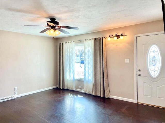 foyer with a ceiling fan, a textured ceiling, baseboards, and wood finished floors