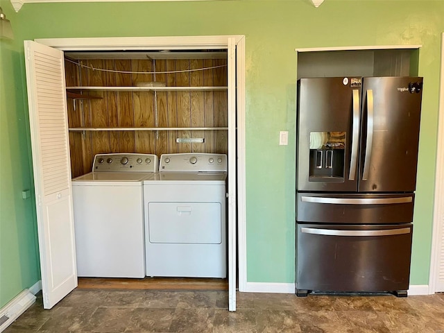 laundry room featuring laundry area, separate washer and dryer, and baseboards