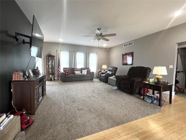 living room with ceiling fan and light wood-type flooring