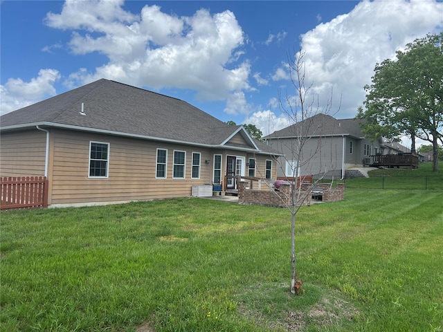 back of house featuring a yard