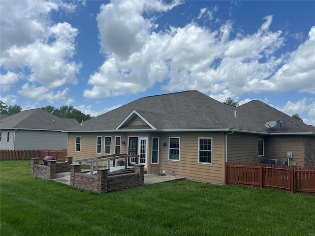 rear view of house featuring a patio area and a lawn