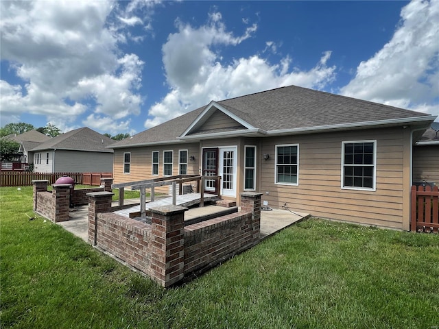 back of property with a yard and a patio