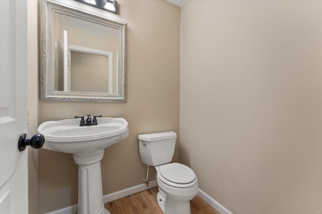 bathroom featuring toilet and hardwood / wood-style floors