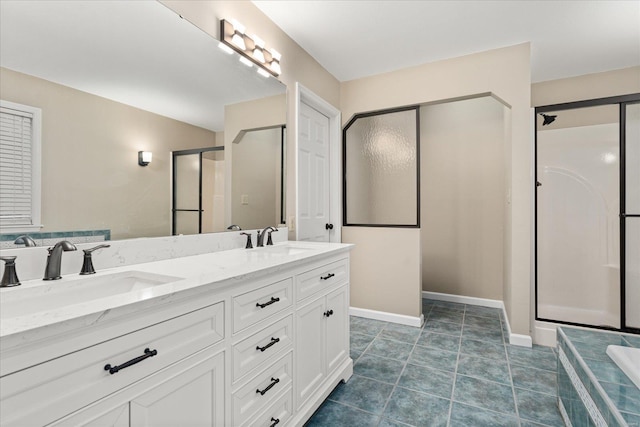 bathroom with walk in shower, vanity, and tile patterned flooring