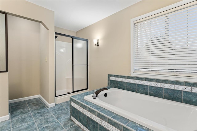 bathroom with tile patterned flooring and plus walk in shower