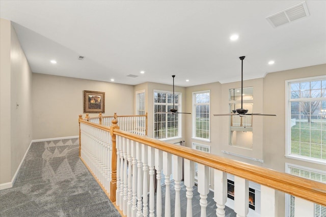 corridor with carpet floors and a wealth of natural light