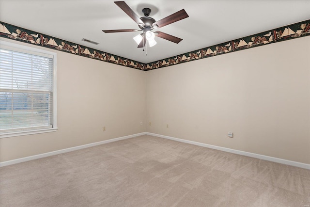 spare room with light colored carpet and ceiling fan