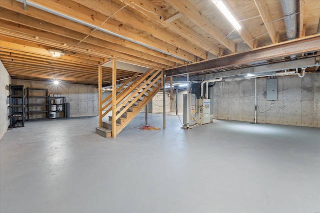 basement featuring electric panel and gas water heater