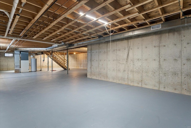 basement with water heater and heating unit