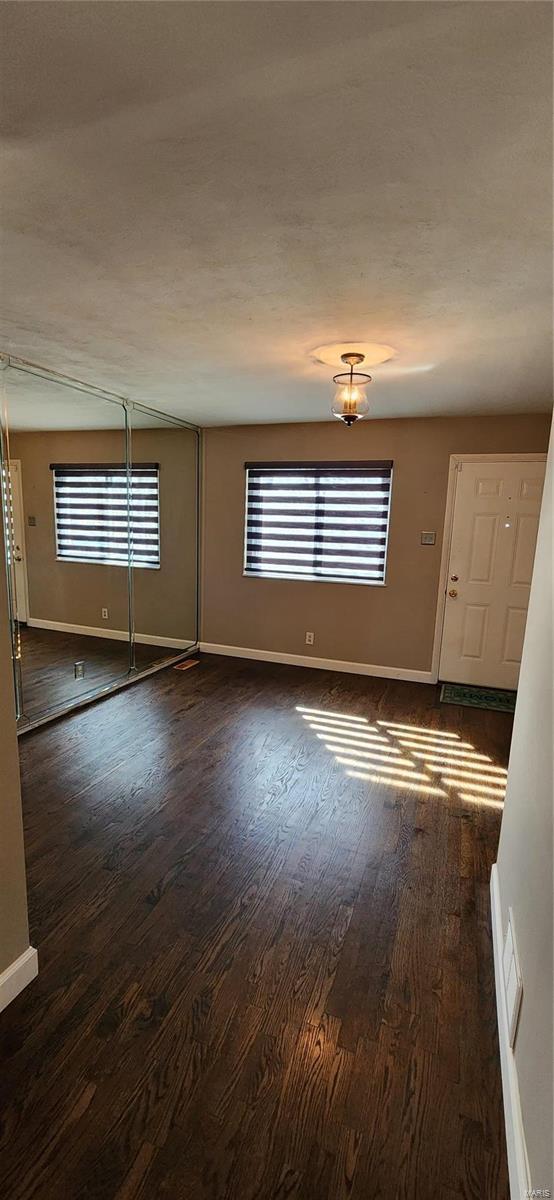 spare room with dark hardwood / wood-style floors