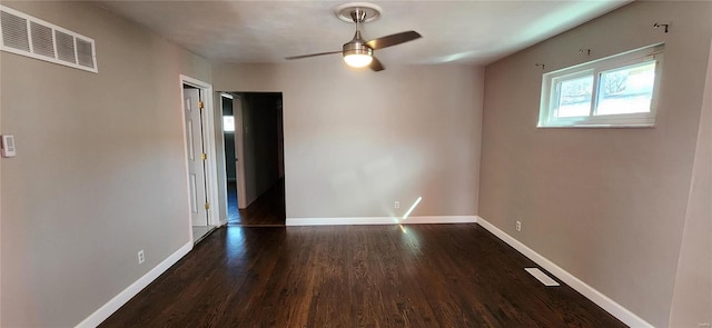 spare room with dark wood-type flooring and ceiling fan