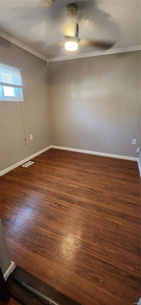 unfurnished room with dark hardwood / wood-style flooring and ornamental molding