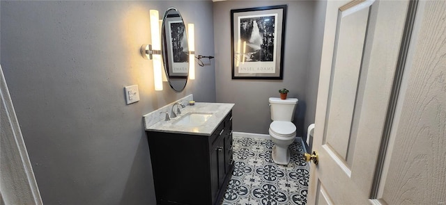 bathroom featuring vanity, tile patterned flooring, and toilet