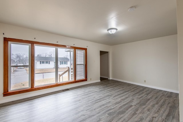 unfurnished room with wood-type flooring