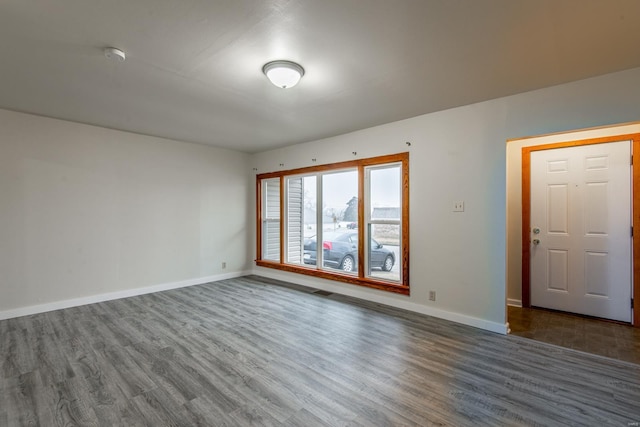 empty room featuring dark wood-type flooring