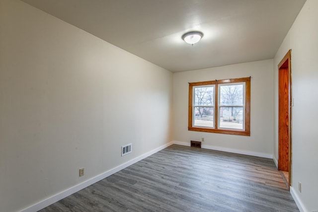 spare room with dark hardwood / wood-style flooring