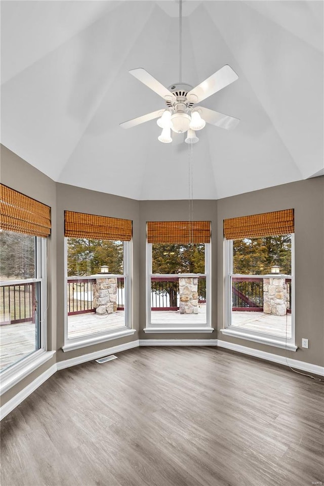 unfurnished sunroom featuring ceiling fan and vaulted ceiling