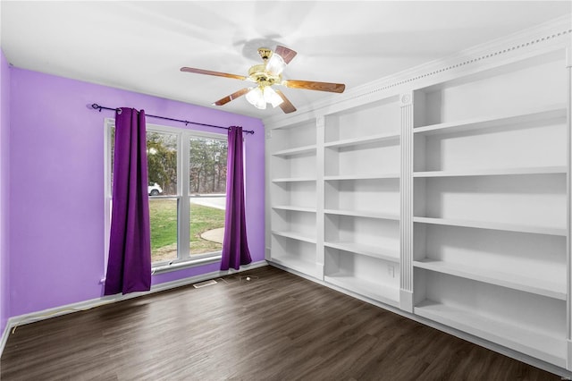 empty room featuring ceiling fan and dark hardwood / wood-style floors