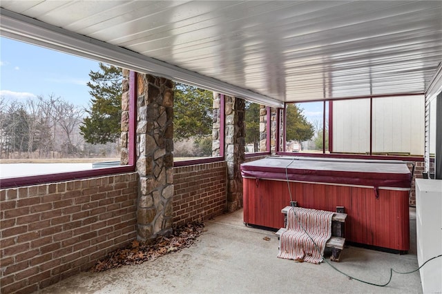 unfurnished sunroom with a jacuzzi