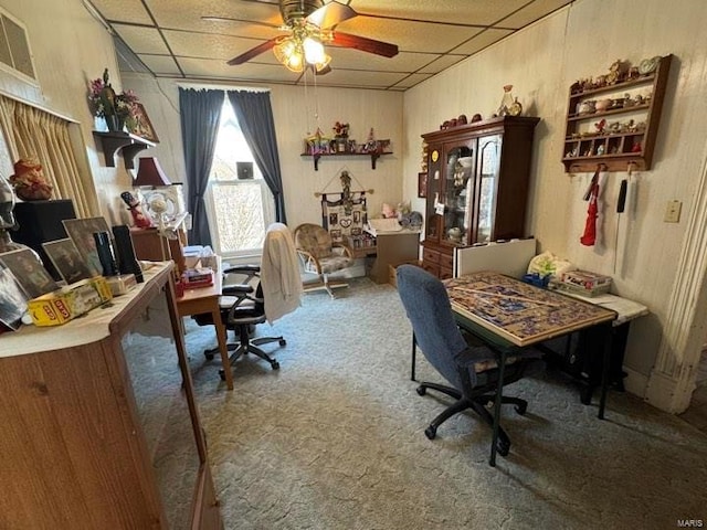 carpeted office with a paneled ceiling and ceiling fan