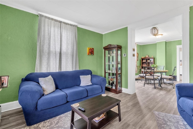 living room featuring hardwood / wood-style flooring and ornamental molding