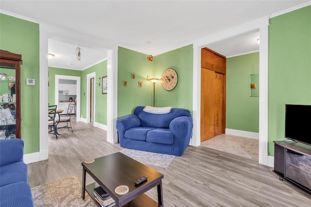 living room featuring ornamental molding and light wood-type flooring