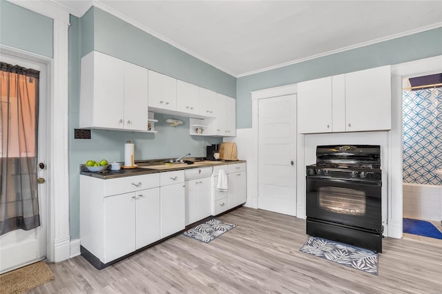 kitchen with sink, white cabinets, ornamental molding, black gas stove, and light wood-type flooring