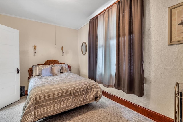 bedroom featuring crown molding and carpet