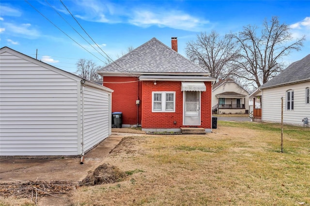 rear view of house with a yard