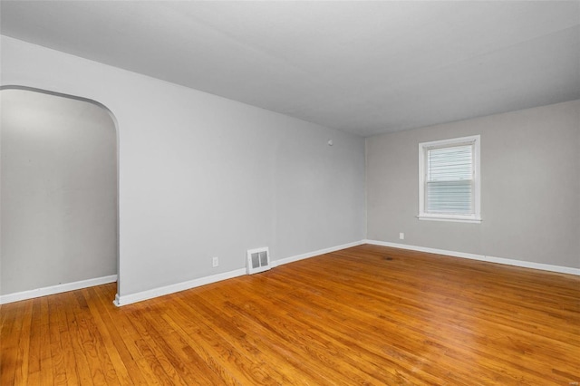 spare room with hardwood / wood-style flooring