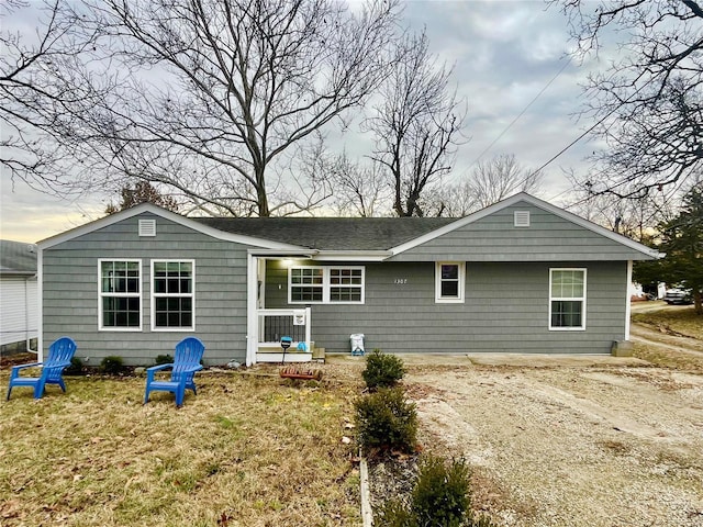 rear view of house featuring a lawn