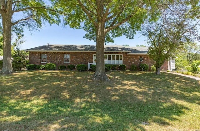 back of property featuring a lawn