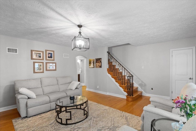 living room with hardwood / wood-style floors and a textured ceiling