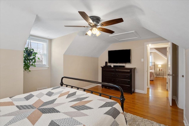 bedroom featuring vaulted ceiling, ceiling fan, and light wood-type flooring