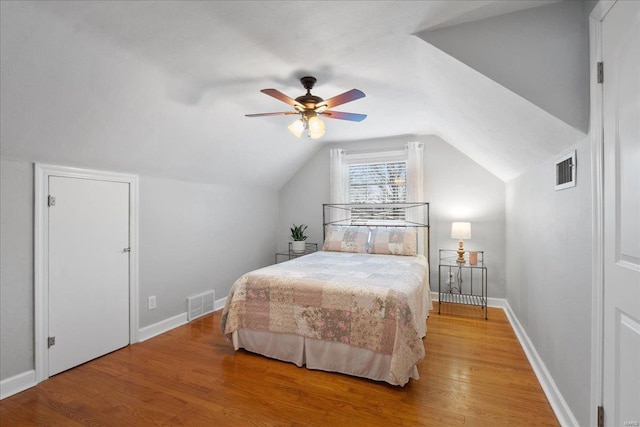 bedroom with lofted ceiling, hardwood / wood-style flooring, and ceiling fan