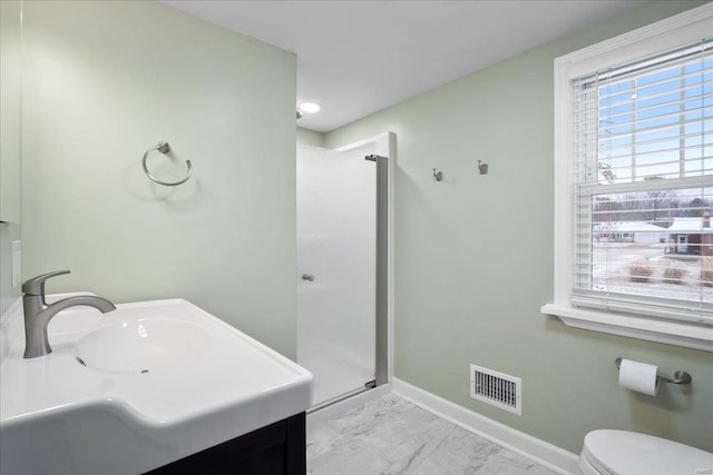 bathroom with vanity, a shower with door, and toilet