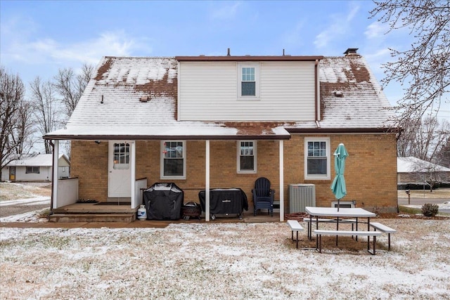 view of snow covered back of property