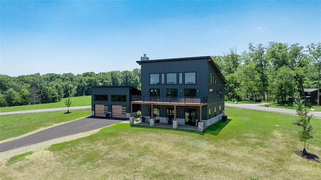 rear view of property with a lawn