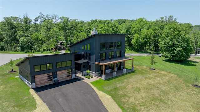 rear view of property featuring a yard and a garage