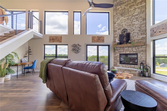 living room with hardwood / wood-style flooring, a fireplace, and a healthy amount of sunlight