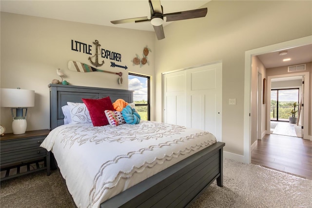 carpeted bedroom featuring a closet and ceiling fan