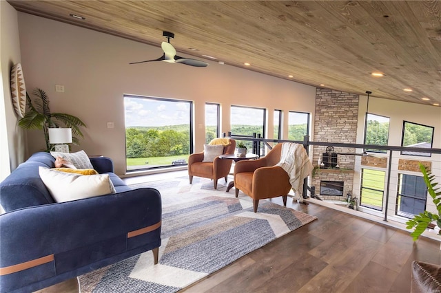 living room featuring hardwood / wood-style flooring, a fireplace, wooden ceiling, and ceiling fan