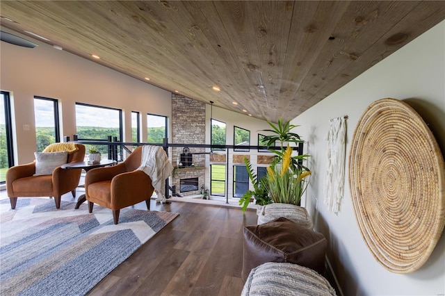 sitting room featuring hardwood / wood-style floors, wooden ceiling, and a fireplace