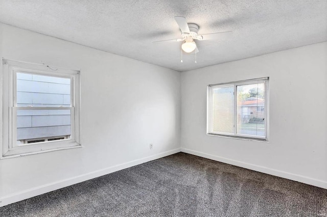 carpeted empty room with a textured ceiling and ceiling fan