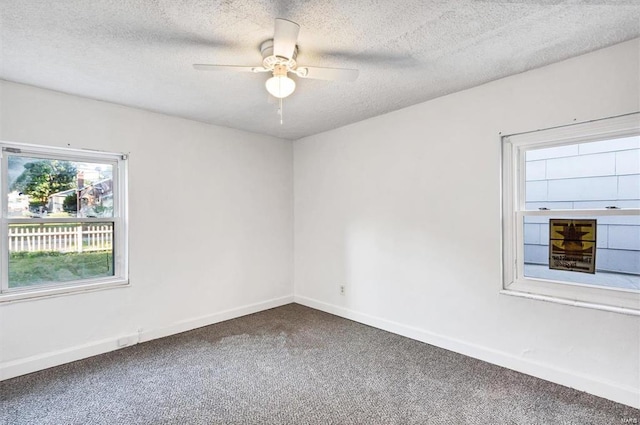 carpeted empty room featuring a textured ceiling and ceiling fan