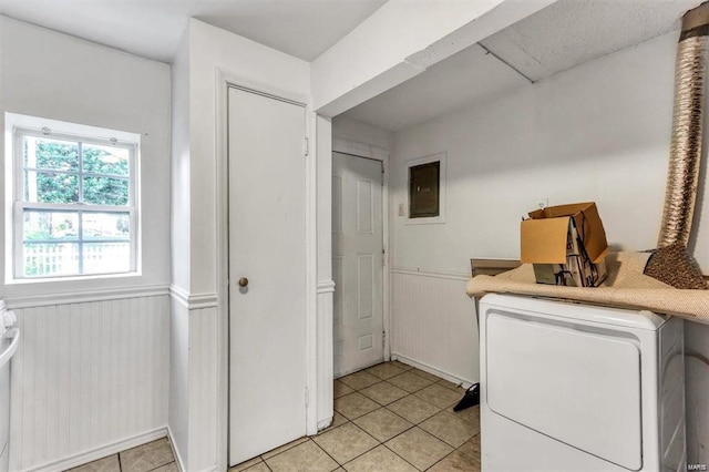 laundry room with light tile patterned flooring and washer / dryer