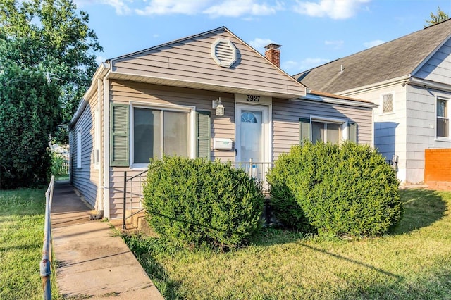 bungalow-style home featuring a front yard