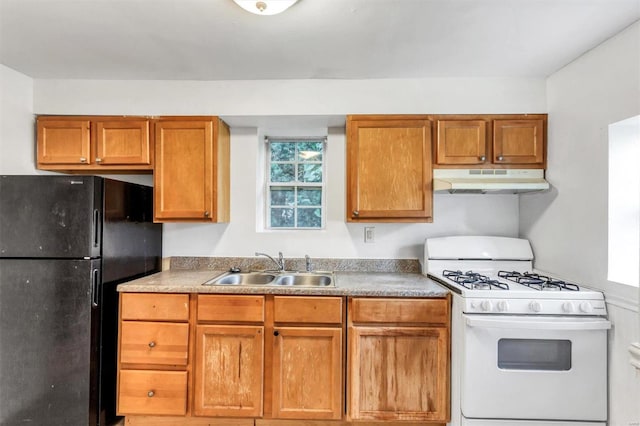 kitchen with black refrigerator, sink, and gas range gas stove